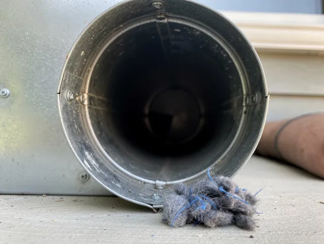 Cypress Dryer Vent Cleaning technician using specialized equipment to clear severe dryer vent blockage in Cypress
